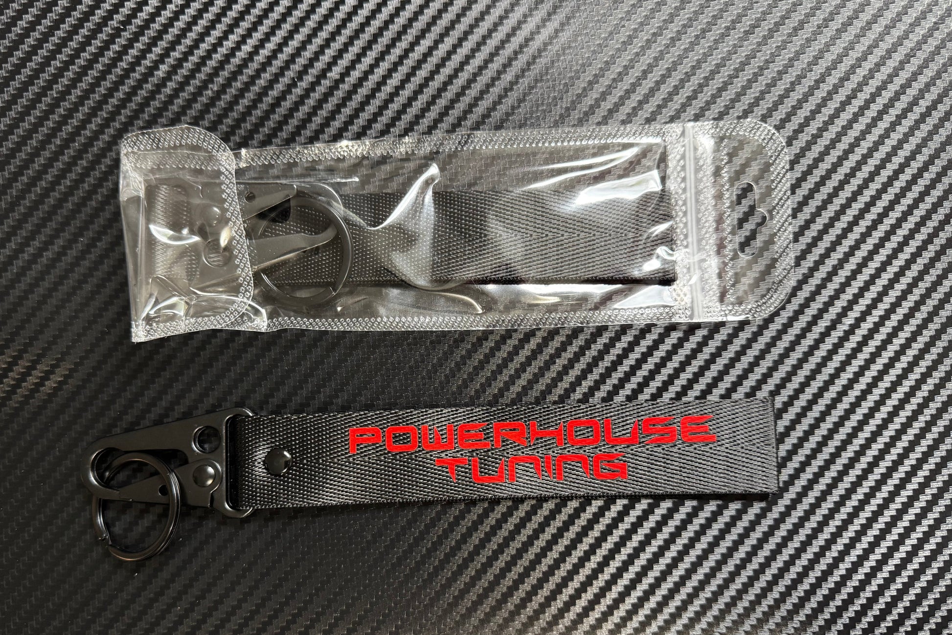 PowerHouse Tuning keychain showing printed red text and silver spring buckle hardware.